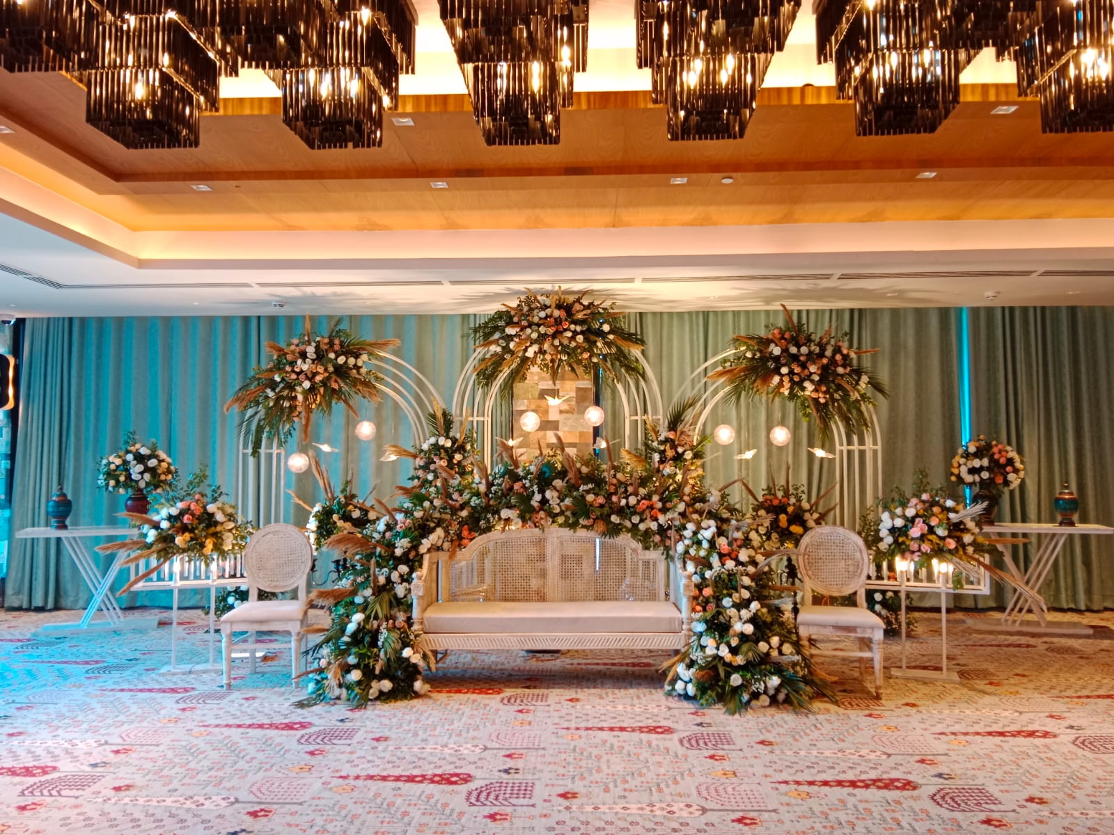 Outdoor destination wedding celebration with balloons and guests