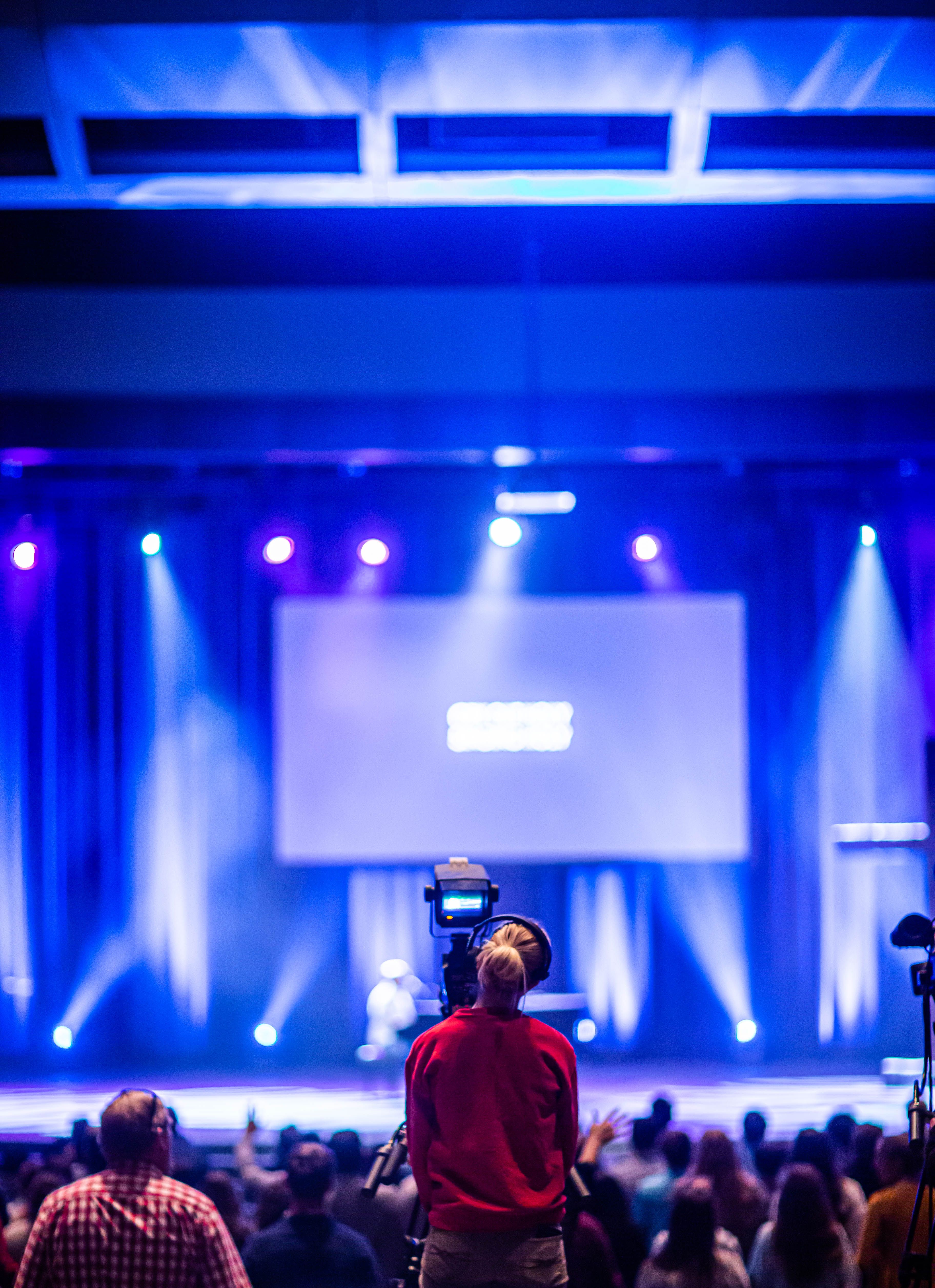 Professional event management setup with stage decor and guest seating